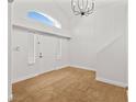 Bright foyer boasts soaring ceilings, a decorative chandelier, and wood look flooring at 9520 Rancho Palmas Dr, Las Vegas, NV 89117