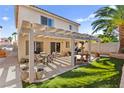 Backyard with a covered patio, a seating area, a water fountain, and artificial grass at 9522 Arrowhead Falls Ct, Las Vegas, NV 89148