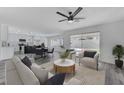 Spacious living room with an open floor plan, showcasing a modern kitchen and access to the backyard pool at 9541 Summersweet Ct, Las Vegas, NV 89123