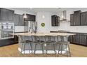 Modern kitchen with a spacious island, stainless steel appliances, granite countertops, and stylish pendant lighting at 9557 Belmont Bay Ave, Las Vegas, NV 89148