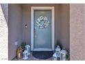 Welcoming front door adorned with a floral wreath and decorative lanterns at 9605 Oliver Hills Ave, Las Vegas, NV 89143