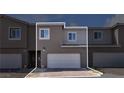 Modern two-story home with attached two-car garage and a brick paved driveway at 9605 Oliver Hills Ave, Las Vegas, NV 89143