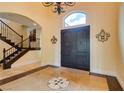 Elegant foyer boasts hardwood flooring, a chandelier, and a view of the staircase at 9749 Glistening Brook Ct, Las Vegas, NV 89149