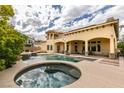 Stunning backyard with a beautiful pool and hot tub and covered patio area, perfect for outdoor enjoyment at 9749 Glistening Brook Ct, Las Vegas, NV 89149