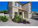Charming two-story home featuring desert landscaping, with a tile roof and covered entry at 10342 Adrianna Ave, Las Vegas, NV 89129