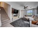 Comfortable living room features modern decor, stairs and large window for lots of natural light at 10342 Adrianna Ave, Las Vegas, NV 89129