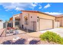 Well-kept single-story house with an enclosed courtyard, desert landscaping, and attached two-car garage at 1057 Neil Armstrong Cir, Las Vegas, NV 89145