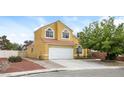 Charming two-story home with a two-car garage, red tile roof, and well-manicured front yard at 1117 Coral Crystal Ct, North Las Vegas, NV 89032