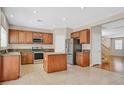 Spacious kitchen featuring an island, stainless steel appliances and tiled flooring with an open floorplan at 11695 Rossovino St, Las Vegas, NV 89183