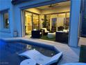 Inviting backyard oasis with a sparkling pool, lounge chairs, and seamless indoor-outdoor living at 12844 New Providence St, Las Vegas, NV 89141
