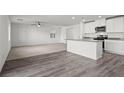 Open living space with luxury vinyl plank flooring, white walls, and recessed lighting throughout at 1656 Desert Path Ave, North Las Vegas, NV 89032