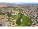 Stunning aerial view of a community surrounding a lush green golf course with serene lakes and beautiful homes at 184 Cullerton St, Las Vegas, NV 89148