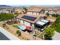 An aerial view of the backyard features a spa, patio, and solar panels on this well kept property at 184 Cullerton St, Las Vegas, NV 89148
