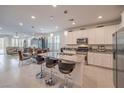 Open-concept kitchen featuring a center island, granite countertops, stainless steel appliances, and white cabinetry at 2114 Thelen Ave, North Las Vegas, NV 89086