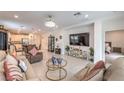 Bright living room featuring neutral walls, tile floors, modern decor, and views of the kitchen and dining area at 2114 Thelen Ave, North Las Vegas, NV 89086