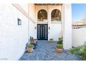 Front entrance with a stylish bench and a modern double-door entry at 2204 Plaza De La Candela, Las Vegas, NV 89102