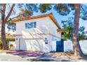 Two-story stucco home featuring a garage and private gated entrance at 2204 Plaza De La Candela, Las Vegas, NV 89102