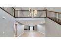 Spacious living room featuring high ceilings, a modern staircase, and open floorplan at 2204 Plaza De La Candela, Las Vegas, NV 89102