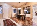 Dining room featuring dark wood floors, a wood table, and decorative art at 2547 Serenity Hollow Dr, Henderson, NV 89052