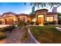 Well-maintained front yard featuring desert landscaping, green lawn, and an arched entryway at 2547 Serenity Hollow Dr, Henderson, NV 89052
