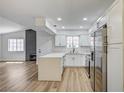 Modern kitchen showcases white cabinets and countertops, flowing into an open living space at 2725 S Nellis Blvd # 2036, Las Vegas, NV 89121