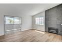Bright living room featuring modern fireplace, sliding glass door, and wood-look flooring at 2725 S Nellis Blvd # 2036, Las Vegas, NV 89121