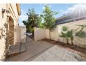 Private patio area with block wall fencing, desert plants, and gated access to the street at 2834 Crystal Lantern Dr, Henderson, NV 89074