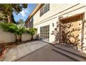 Covered back patio with a sliding glass door and gate leading to the yard at 2834 Crystal Lantern Dr, Henderson, NV 89074