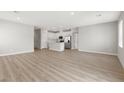 Bright and spacious living area featuring modern light gray walls and stylish wood-look flooring throughout at 3228 Lahontan St, North Las Vegas, NV 89032