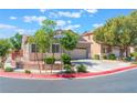 Beautiful single-story home with attached garage, concrete driveway, and verdant landscaping at 329 Gemstone Hill Ave, North Las Vegas, NV 89031