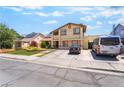 Beige stucco house with solar panels and a spacious driveway at 4356 Sabadell St, Las Vegas, NV 89121