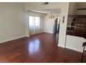 Spacious living room featuring wood floors, neutral walls, and windows with decorative curtains at 4356 Sabadell St, Las Vegas, NV 89121