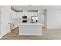 Contemporary kitchen featuring white cabinets, stainless steel appliances, and a center island at 4417 Pioche Ave, North Las Vegas, NV 89032