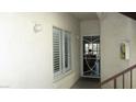 Inviting entryway with white shutters, and a secure door leading into the home at 4821 Black Bear Rd # 104, Las Vegas, NV 89149