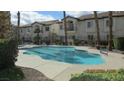 Community pool surrounded by well-maintained landscaping and nearby buildings at 4821 Black Bear Rd # 104, Las Vegas, NV 89149