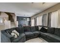 Bright living room featuring a large sectional, staircase, and contemporary decor at 5509 Ante Up Ct # 102, Las Vegas, NV 89122