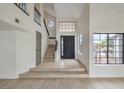 Bright foyer with high ceilings, staircase, and large windows, creating a welcoming entrance at 6 Megan Dr, Henderson, NV 89074