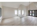 Open living room area with vaulted ceilings and door to pool area at 6 Megan Dr, Henderson, NV 89074
