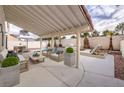 Relaxing covered patio features stylish seating and a view of the pool area at 6 Megan Dr, Henderson, NV 89074