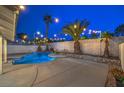 Inviting backyard with a refreshing pool, mature palms, and relaxing seating area at 6 Megan Dr, Henderson, NV 89074