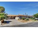 Inviting single-story home with a well-kept yard, mature trees, and a lengthy driveway at 6225 Rassler Ave, Las Vegas, NV 89107