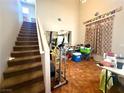 View of the open floor plan, stairs to the second floor and tile flooring at 6287 Stone Hollow Ave, Las Vegas, NV 89156
