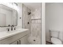 Modern bathroom features mosaic tile floor, and stylish vanity with sleek black hardware at 6308 Lawton Ave, Las Vegas, NV 89107