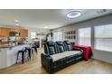 Open floorplan showcasing living area with a comfortable leather couch and adjacent eat-in kitchen at 8733 Autumn Teal Ave, Las Vegas, NV 89178