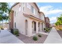 Exterior view of a home with neutral colors, a tiled roof, and easy access to a sidewalk at 965 Nevada State Dr # 15104, Henderson, NV 89002