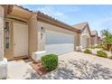 Inviting single-story home with a private entrance, attached two-car garage, and lush landscaping at 9688 Meeks Bay Ave, Las Vegas, NV 89148