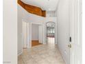 Bright and airy foyer with tile flooring, neutral paint, and an open view into other rooms at 9688 Meeks Bay Ave, Las Vegas, NV 89148