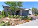 Charming single-story home with desert landscaping, a cozy porch, and a warm, inviting curb appeal at 10049 Cardinal Knoll Ave, Las Vegas, NV 89143