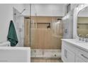 Modern bathroom featuring a walk-in shower with wood-look tile accent wall at 10801 Clarion Ln, Las Vegas, NV 89134