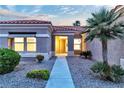 Inviting front entrance with well-maintained landscaping, stone accents, and a charming walkway at 10801 Clarion Ln, Las Vegas, NV 89134